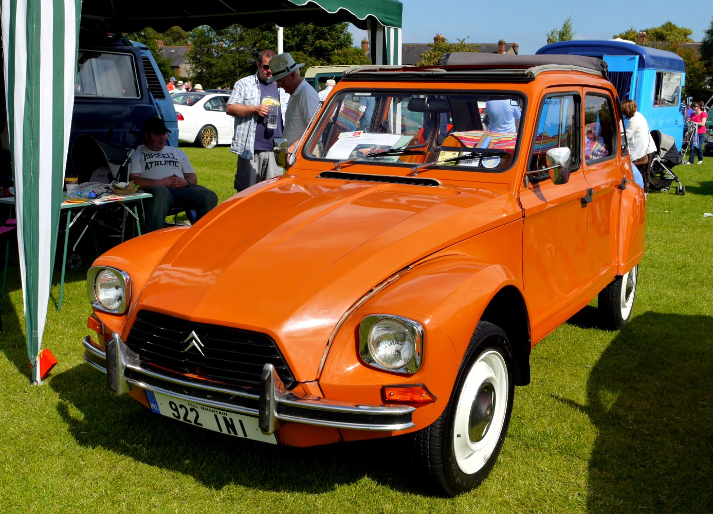 Vintage orange car front with dual square headlights and chrome bumper
