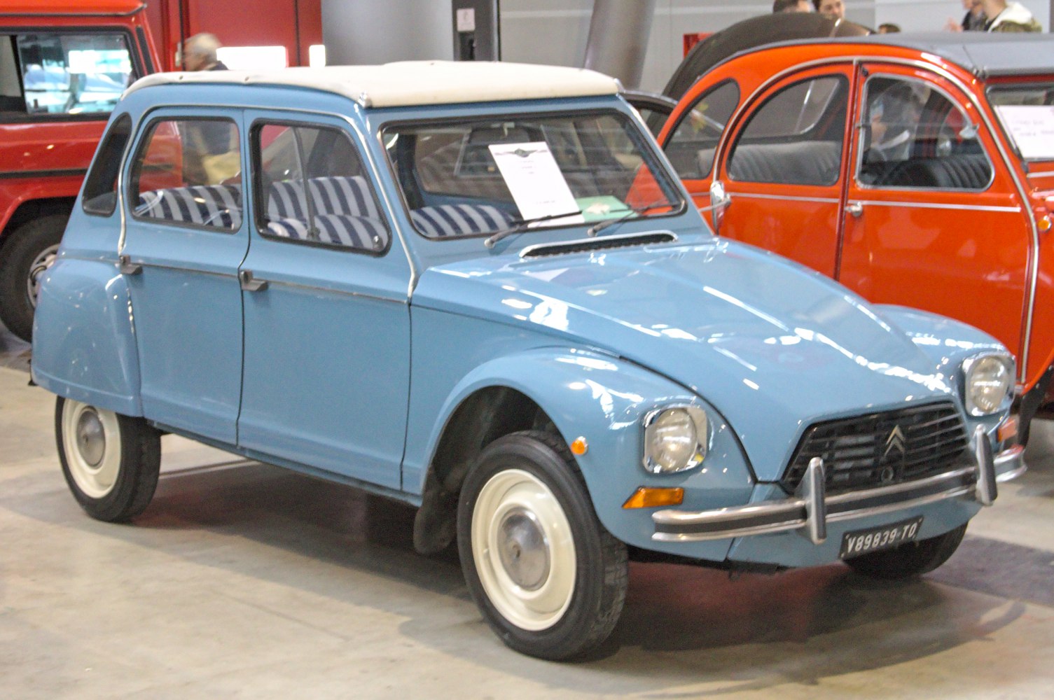 Classic blue vintage compact sedan with rounded design and striped interior