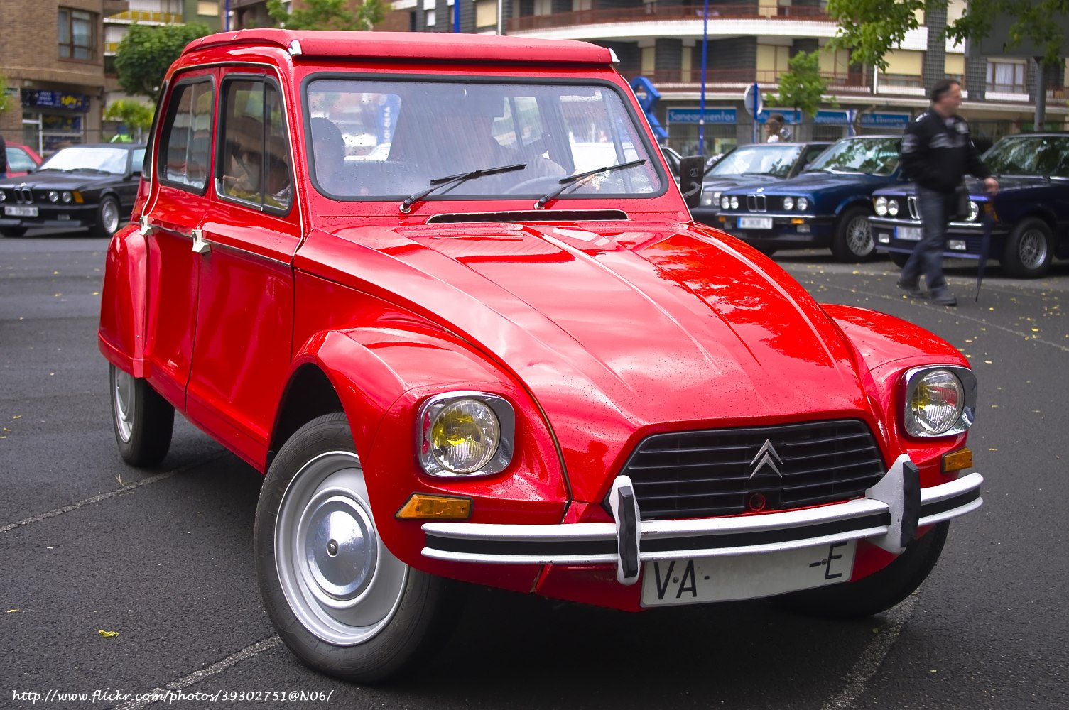 Red vintage hatchback with round headlights and distinctive grille
