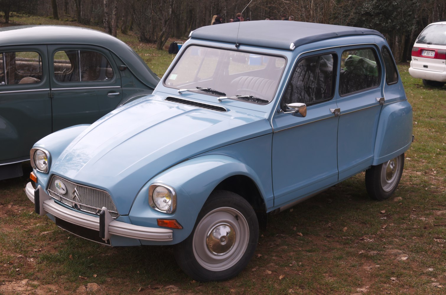 Light blue vintage economy hatchback with fabric roof and rounded headlights