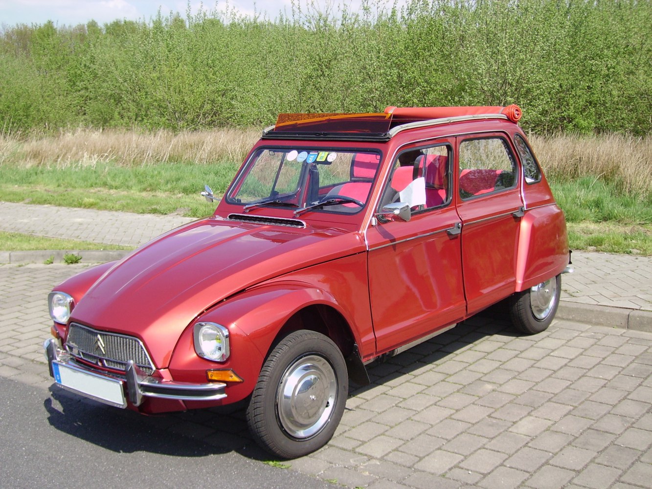 Vintage hatchback with rolling canvas roof and chrome front grille