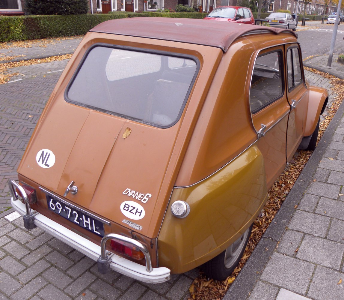 Rear view of a vintage compact car with fabric sunroof and rounded rear window