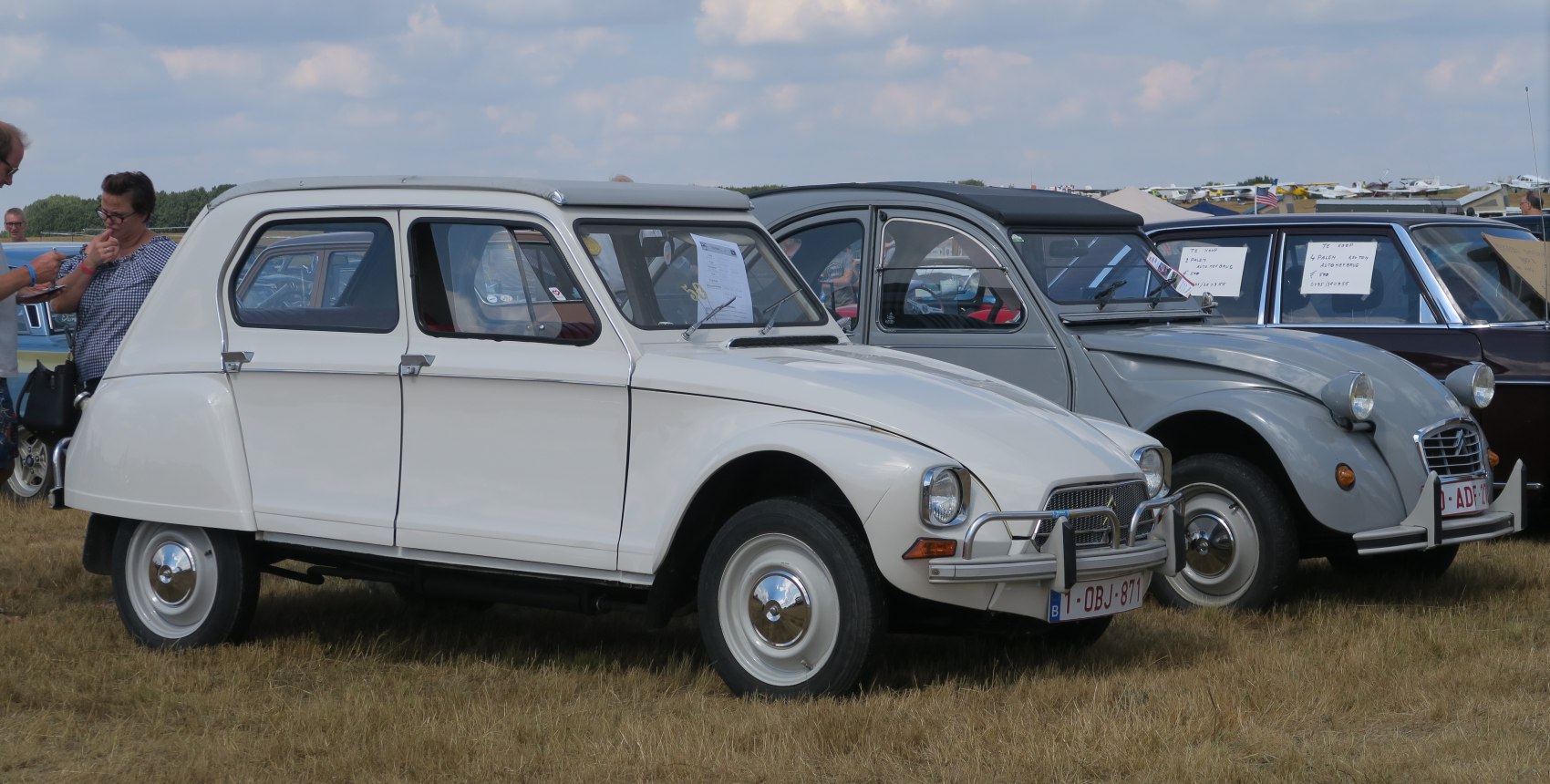 White vintage hatchback with round headlights and compact body