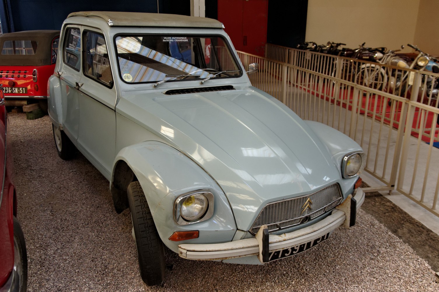 Vintage compact car with square headlights and wide grille