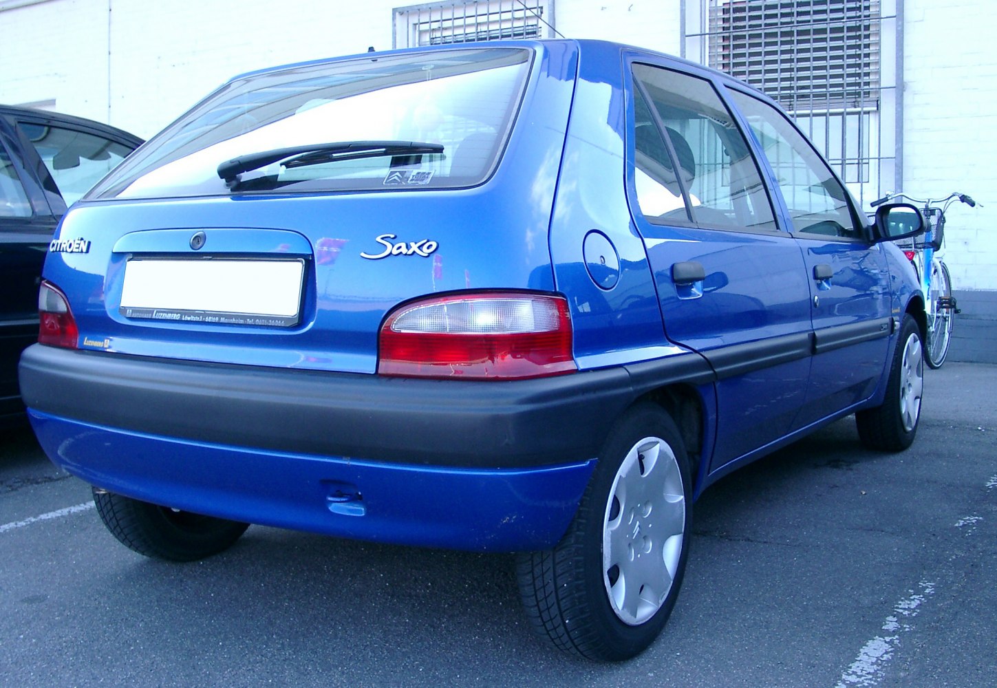 Blue 5-door hatchback rear and side with taillights and wheel cover
