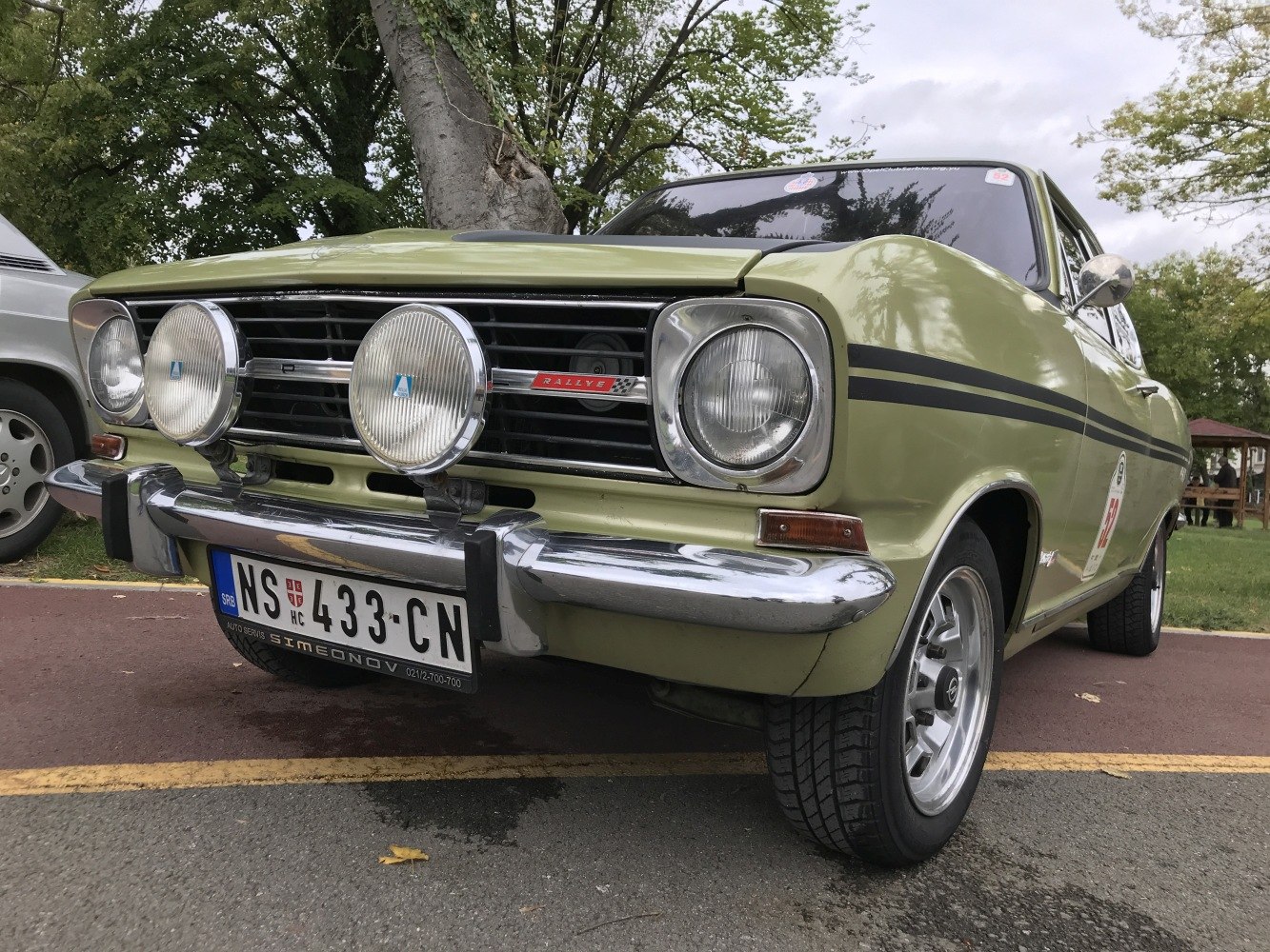 Front view of a vintage car with rally additional lights and chrome bumper