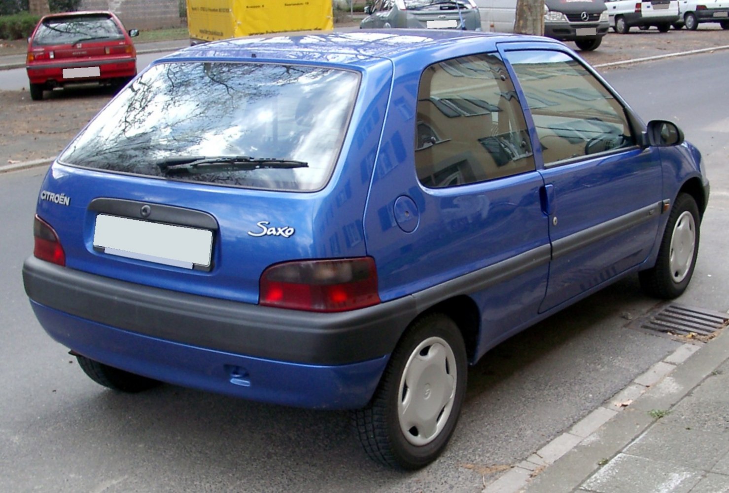 Rear view of a blue compact hatchback with black bumper and distinctive taillights.