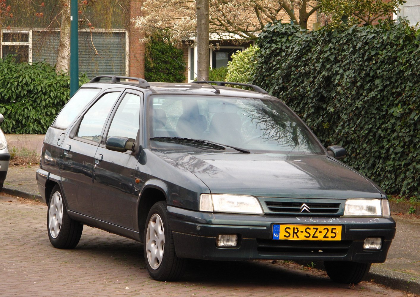 Front-side view of a compact station wagon with roof rails and angular headlights