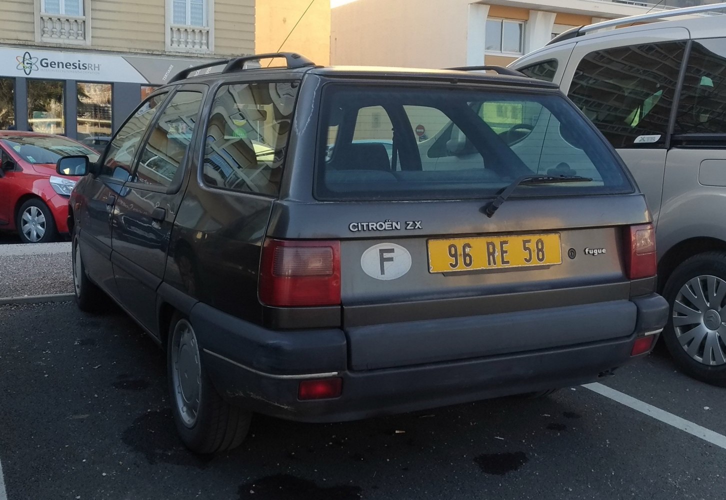 Rear view of estate car with tailgate window, roof rails, and rear wiper