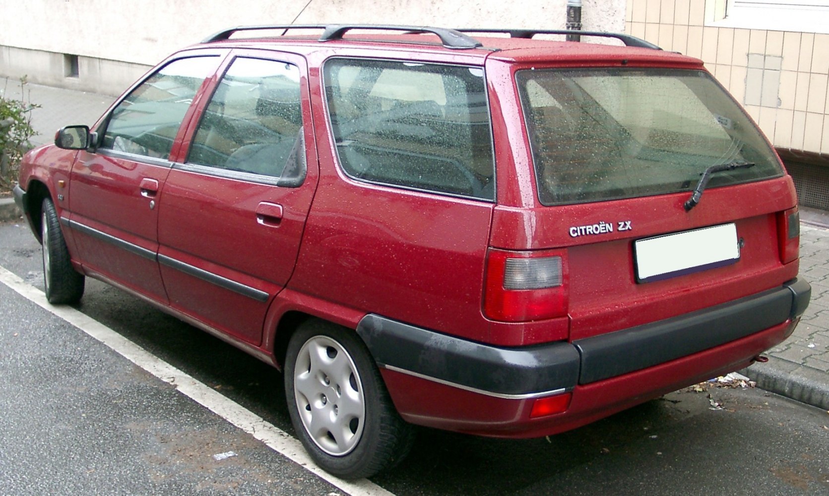 Red station wagon rear and side view with rear windshield wiper