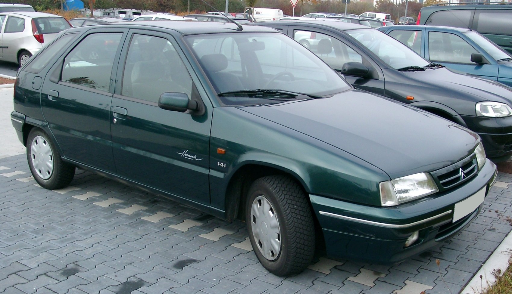 90s 5-door aerodynamic hatchback with smooth lines and compact body