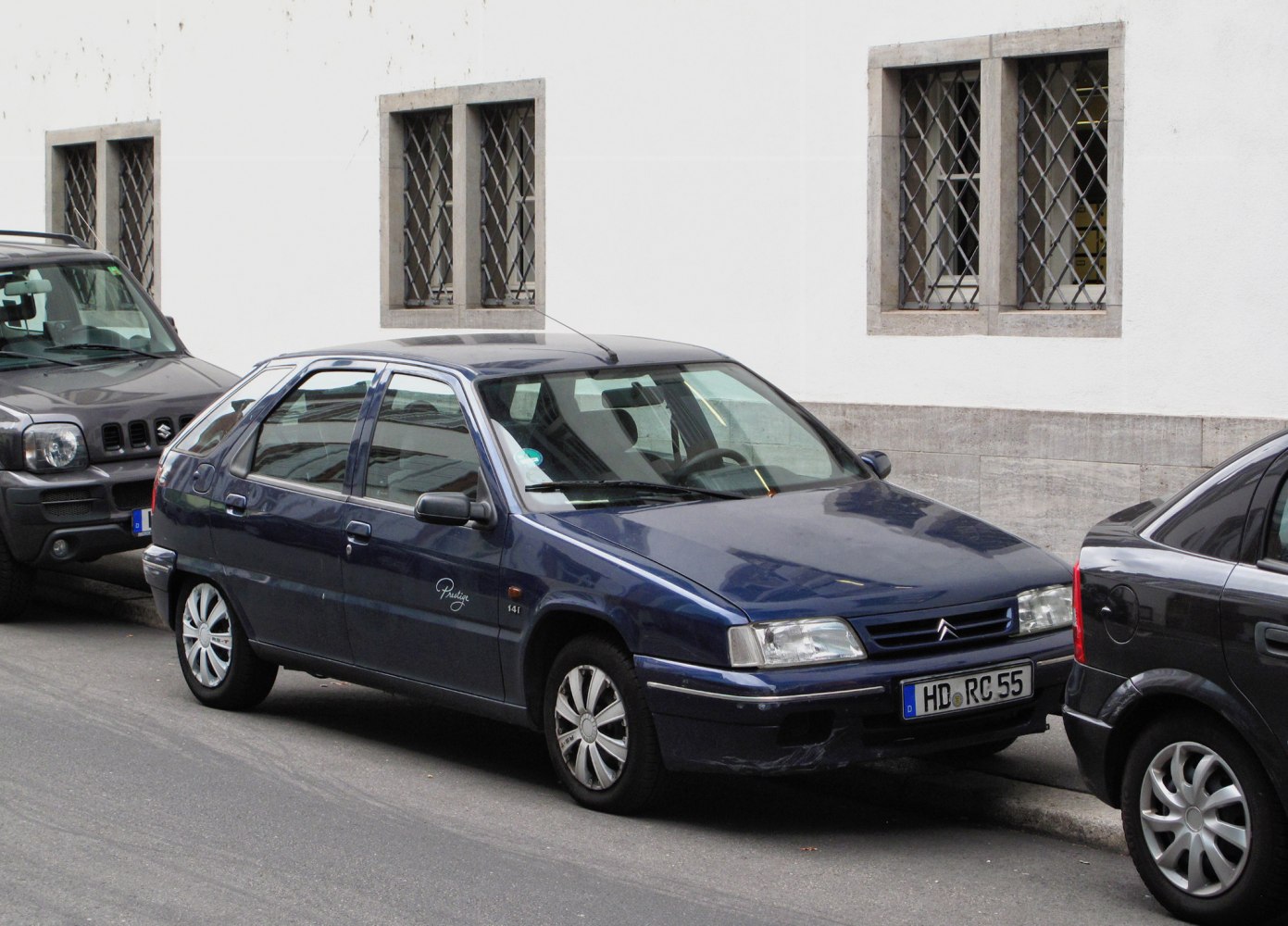 Blue 5-door hatchback with boxy shape and alloy wheels