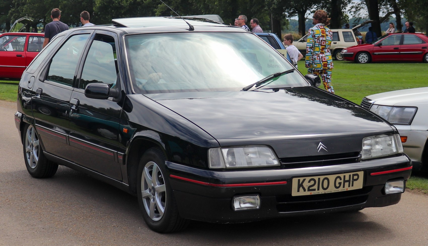 Black 5-door hatchback with rectangular headlights and alloy wheels