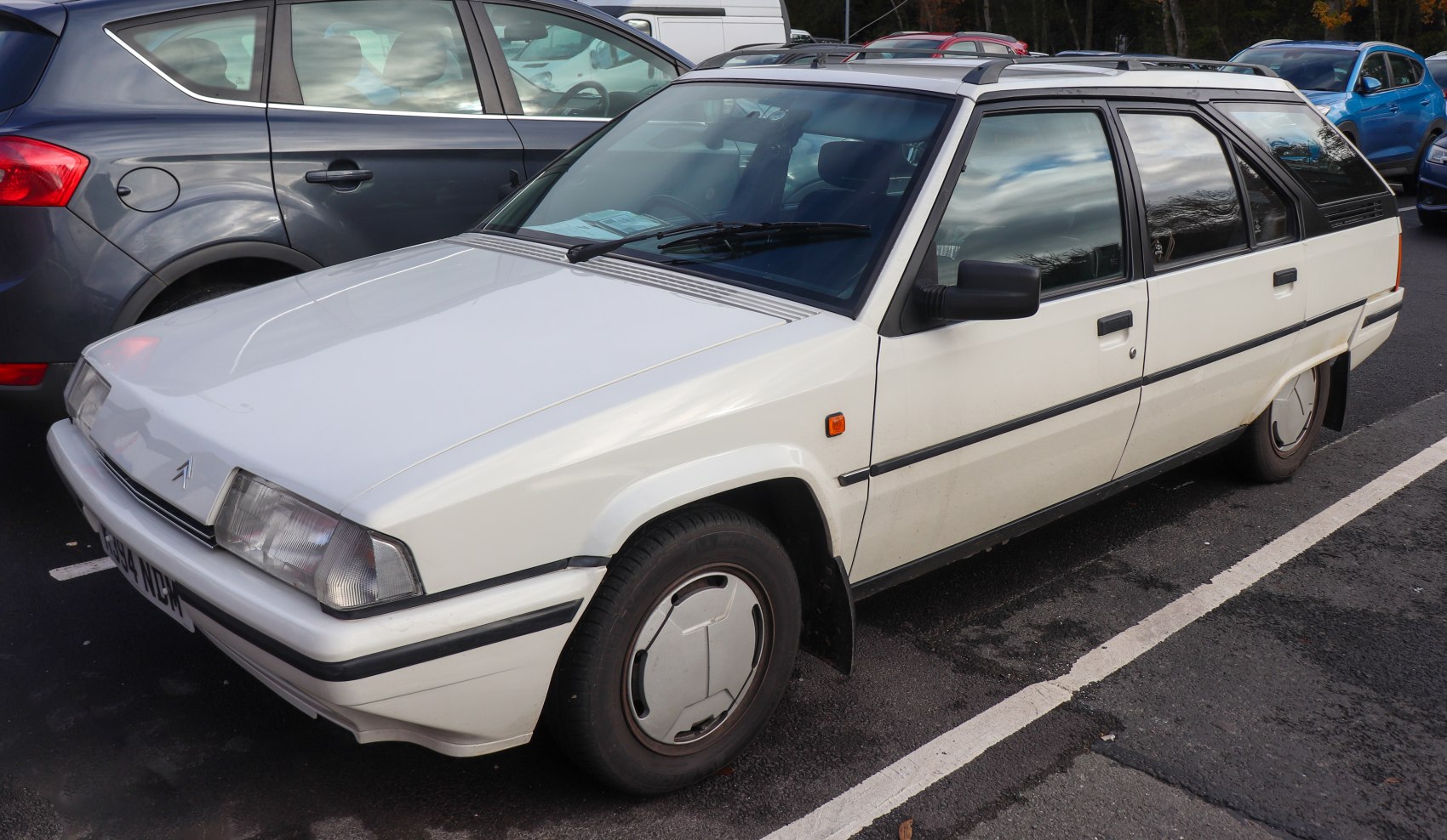 White retro station wagon with angular design and covered wheels
