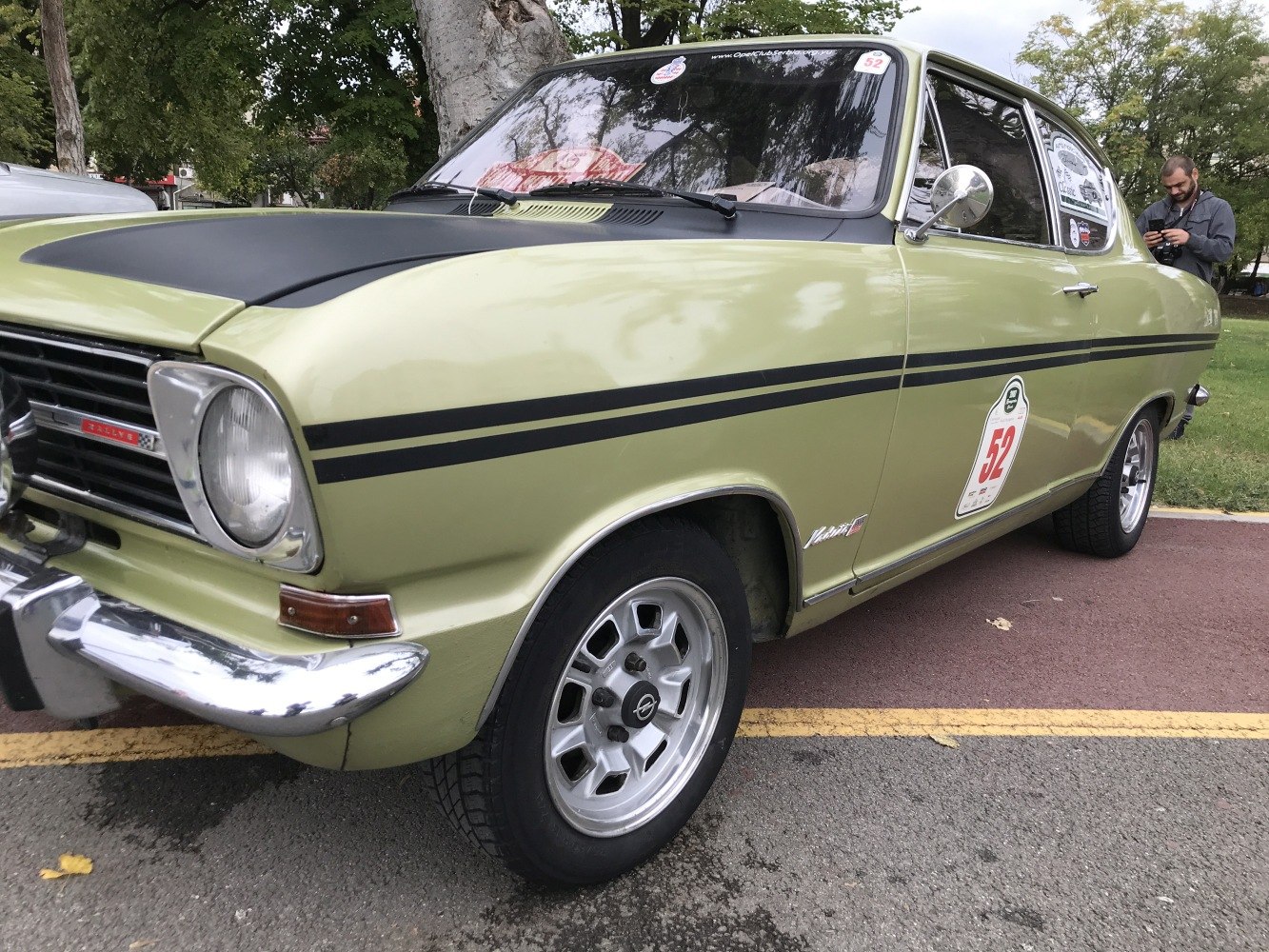Front and side profile of a vintage coupe with rally decals and distinctive styling