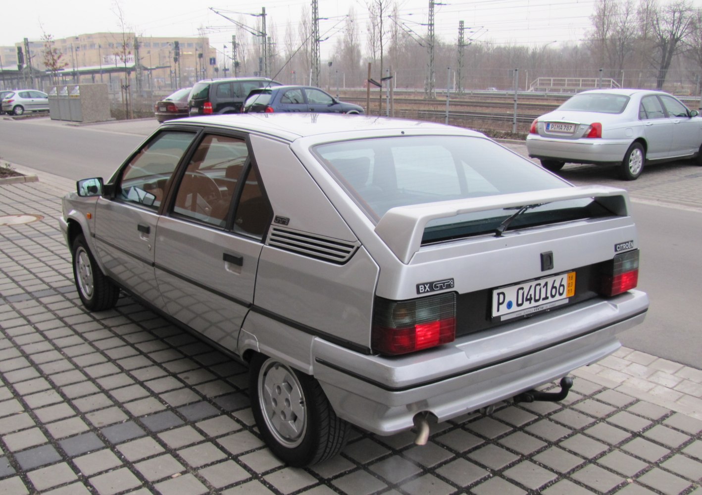 Rear and side hatchback view with integrated spoiler and distinct taillights