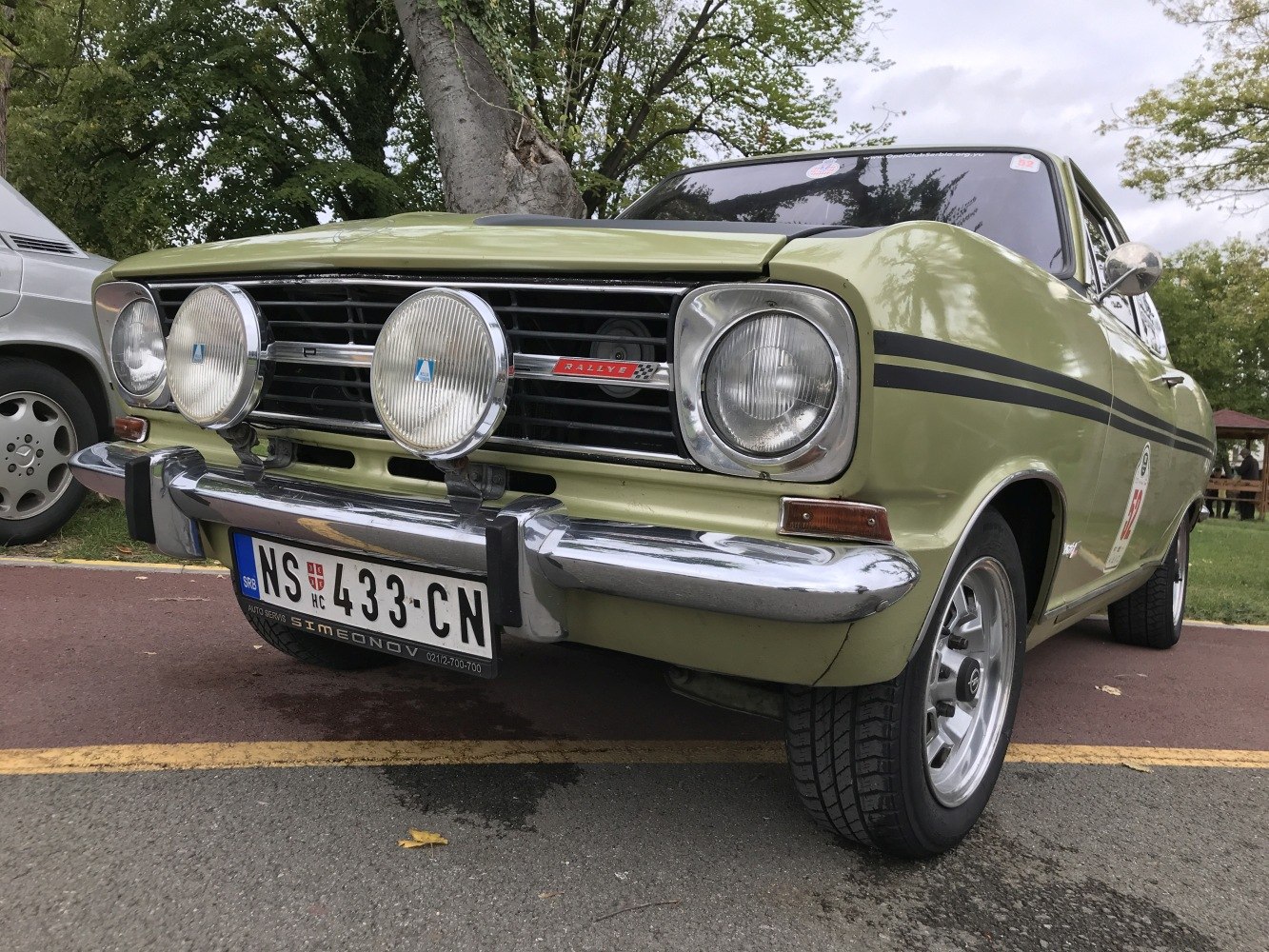Close-up of vintage coupe front with rally lights and chrome bumper