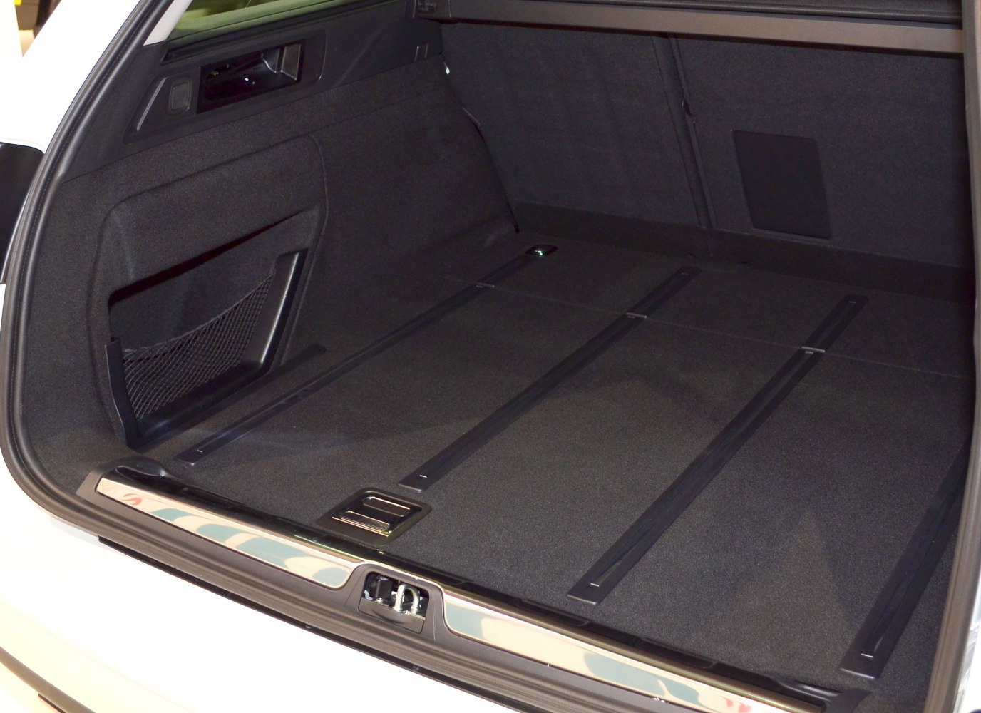 Spacious rear cargo area with storage net and floor rails
