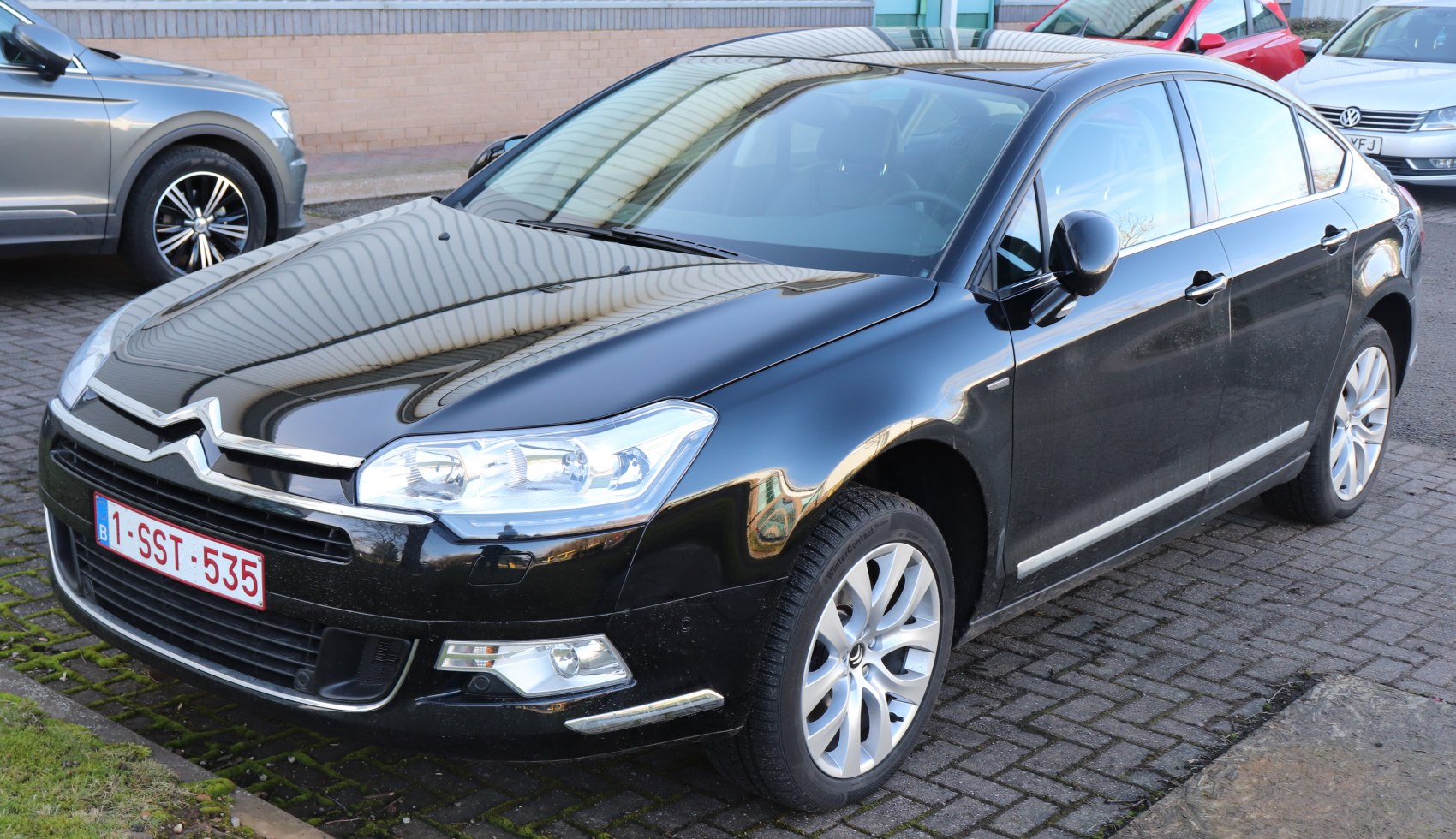 Black luxury sedan with alloy wheels and sleek front grille