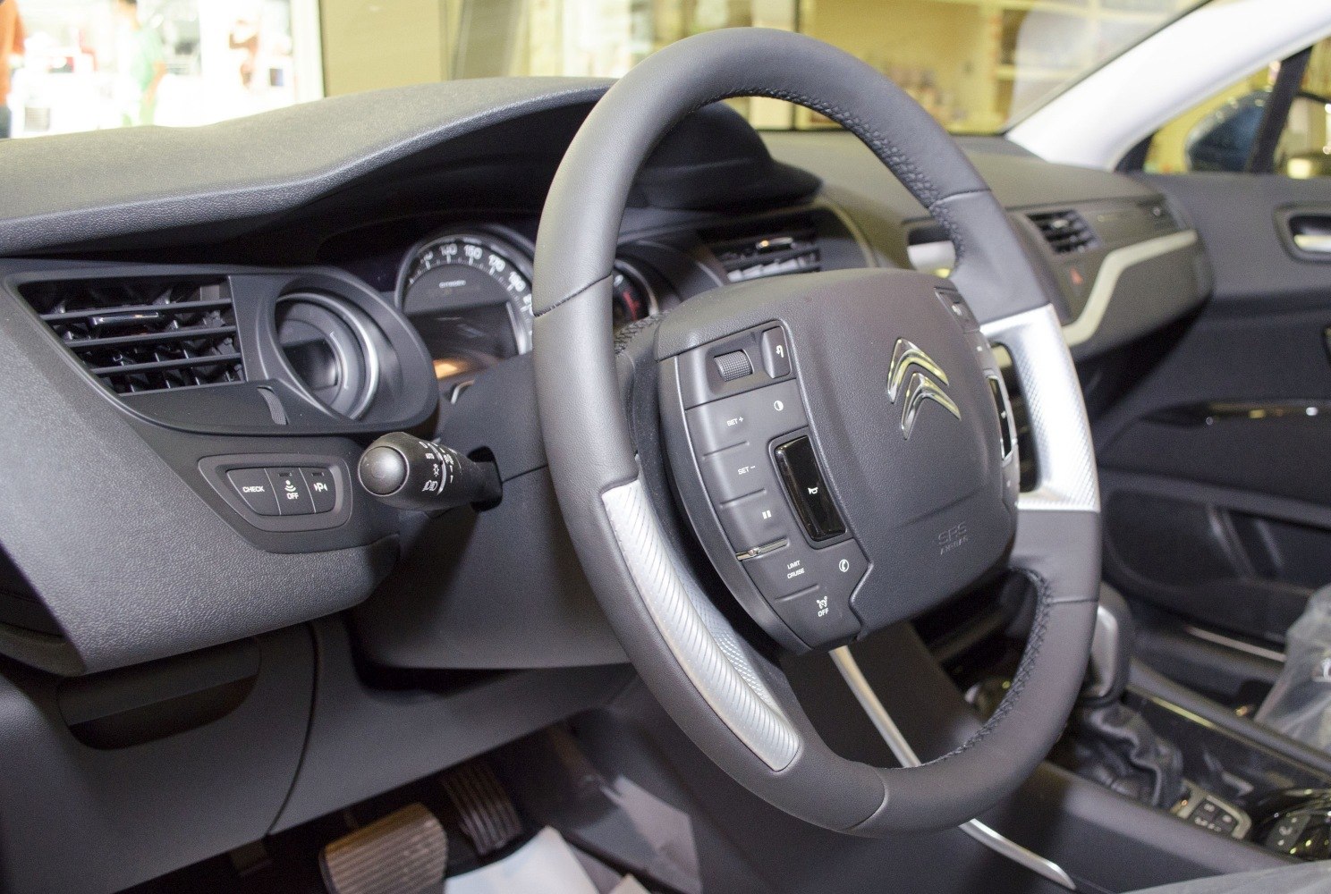 Steering wheel with multiple integrated control buttons and dashboard air vents