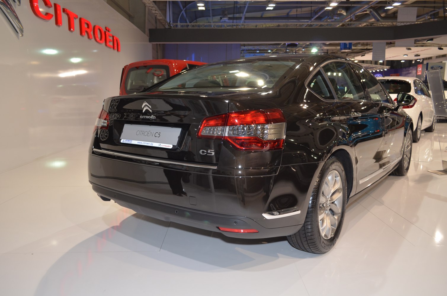 Rear and side view of black mid-size sedan with modern taillights.