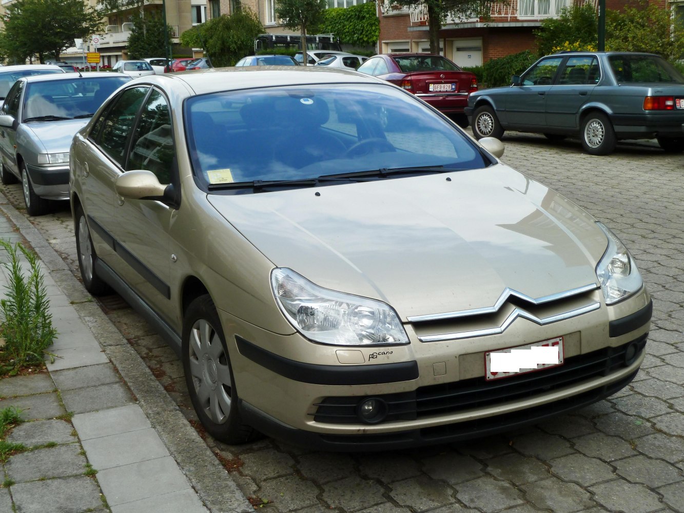 Front view of a sedan with distinctive grille and clear headlights