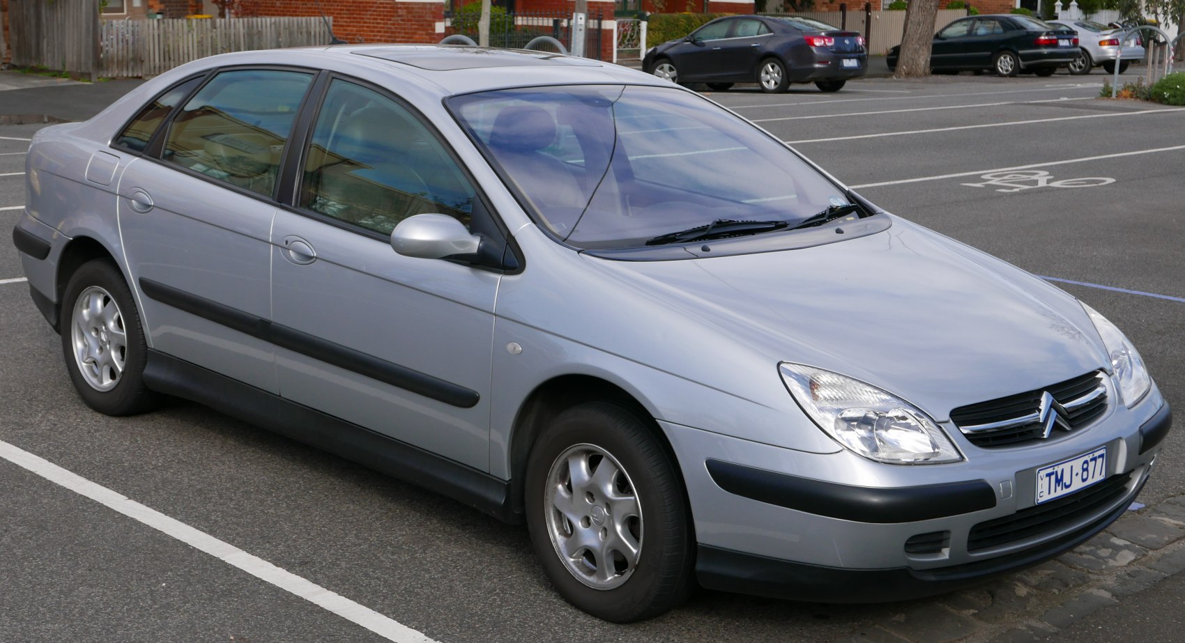 Side-front angle of silver mid-size sedan with alloy wheels