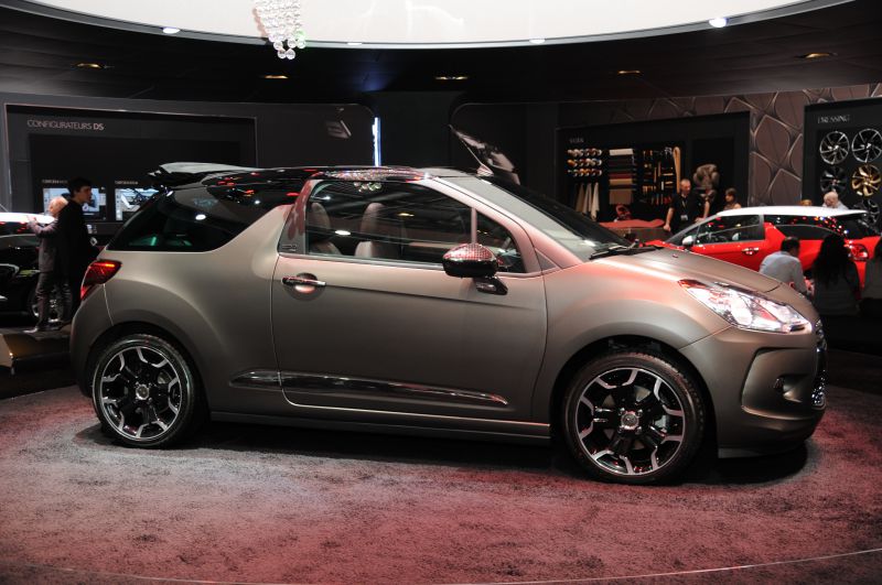 Side profile of a compact convertible with unique wheels and distinctive roof design