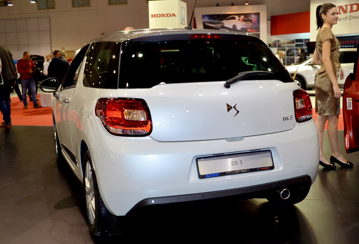 Rear view of white compact hatchback with distinct tail lights