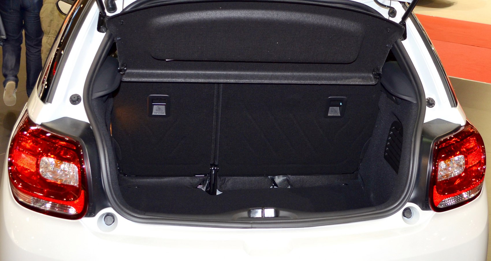 Open hatchback trunk interior with visible rear tail lights and storage space
