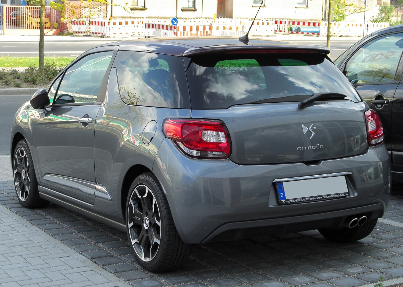 Rear perspective of a compact hatchback with distinct tail lights and alloy wheels