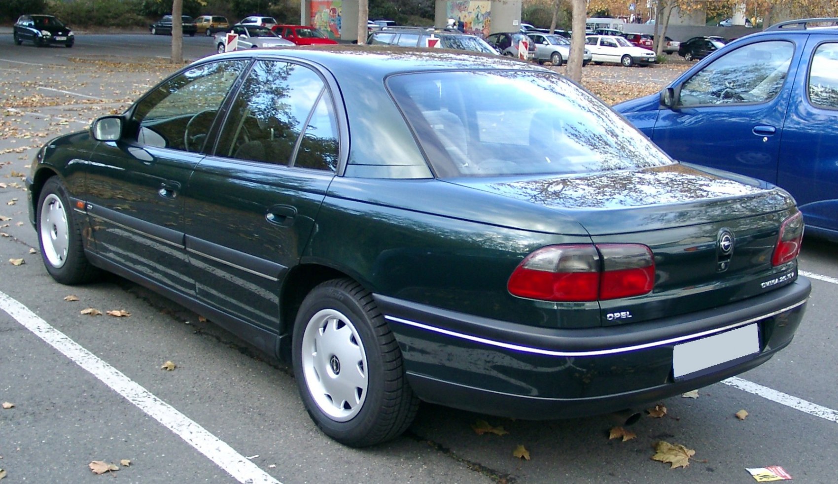 Rounded rear and side profile of a mid-90s sedan in a parking lot