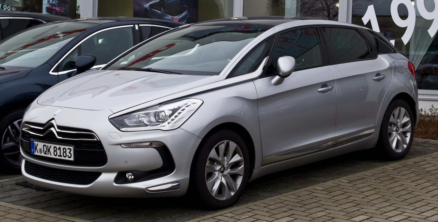 Silver compact hatchback with LED headlights and aerodynamic design