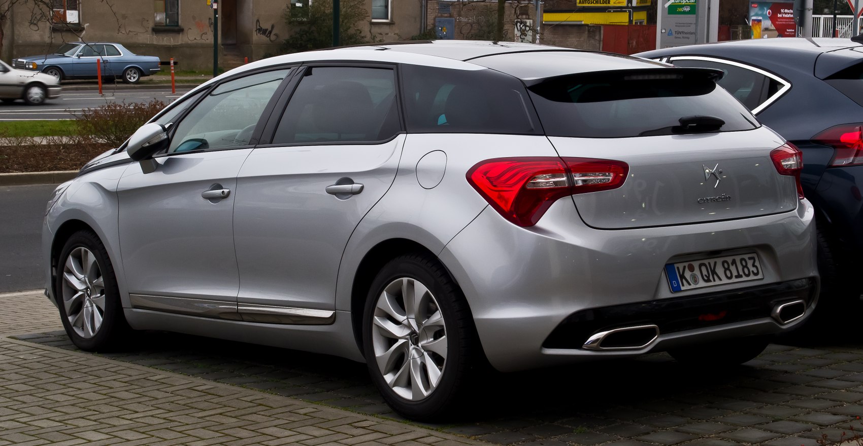 Rear side view with distinctive taillights and dual exhausts