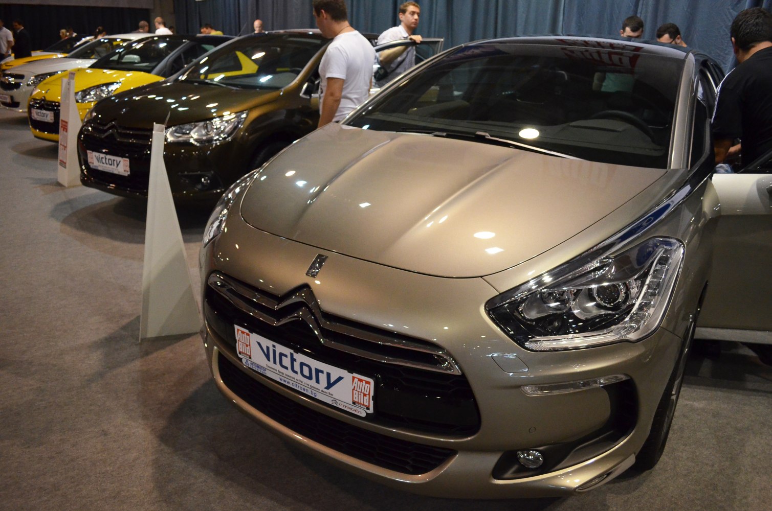 Close-up of front car with detailed LED headlights and bold grille