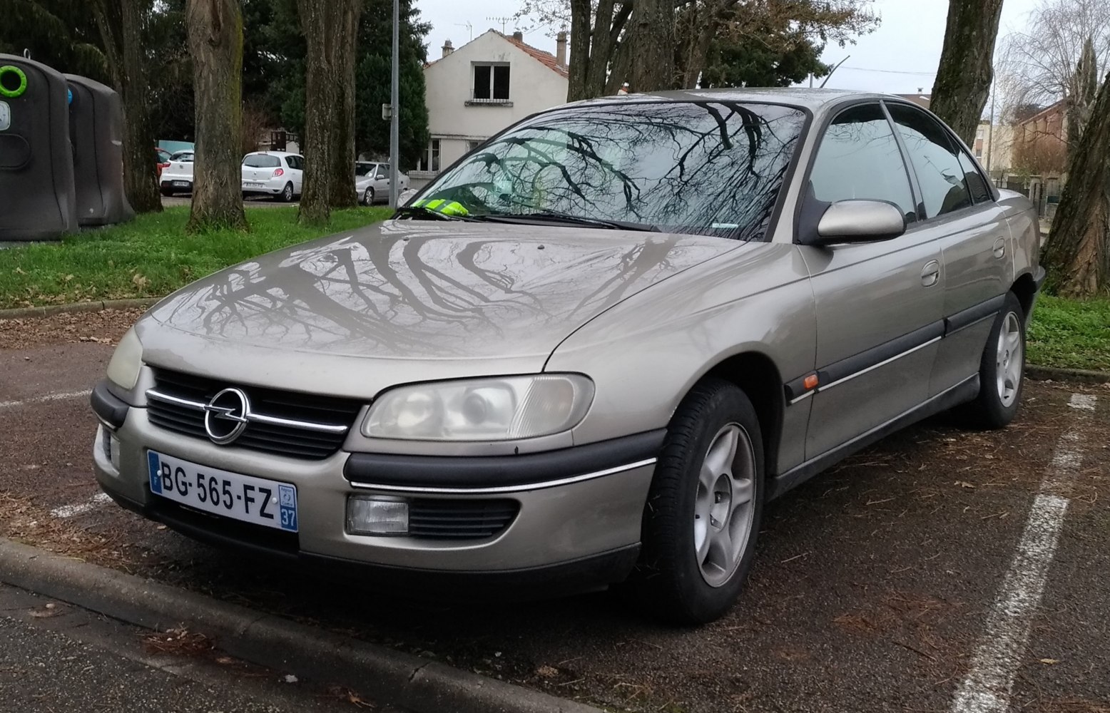 Silver sedan with integrated headlights and smooth body lines parked outdoors
