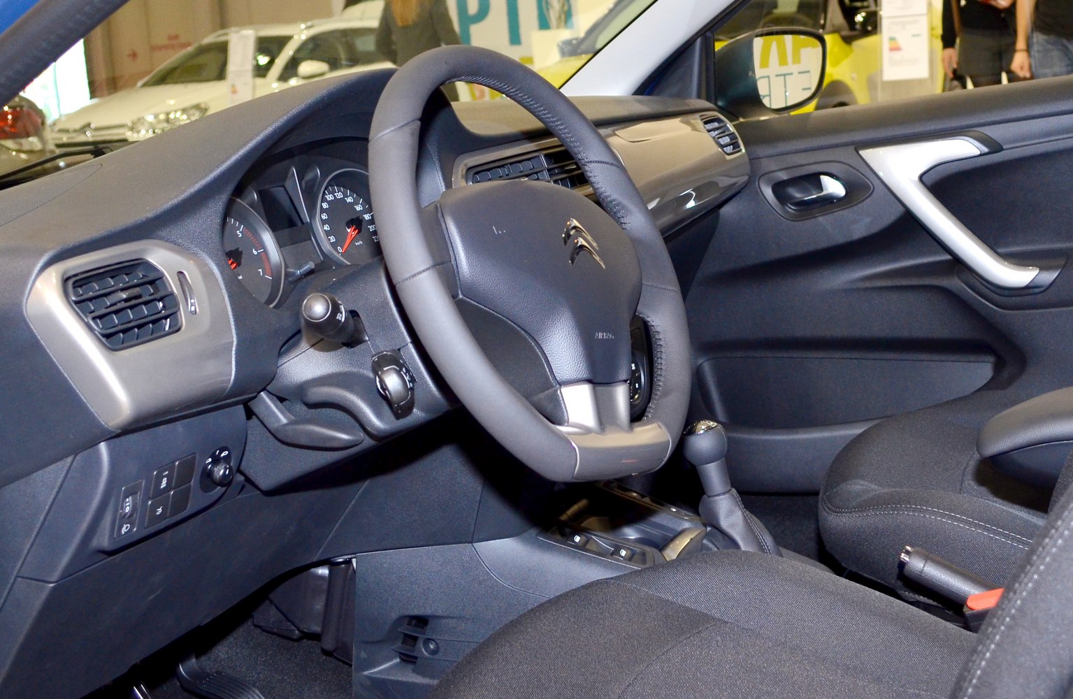 Dashboard with steering wheel, gear shift, and interior controls