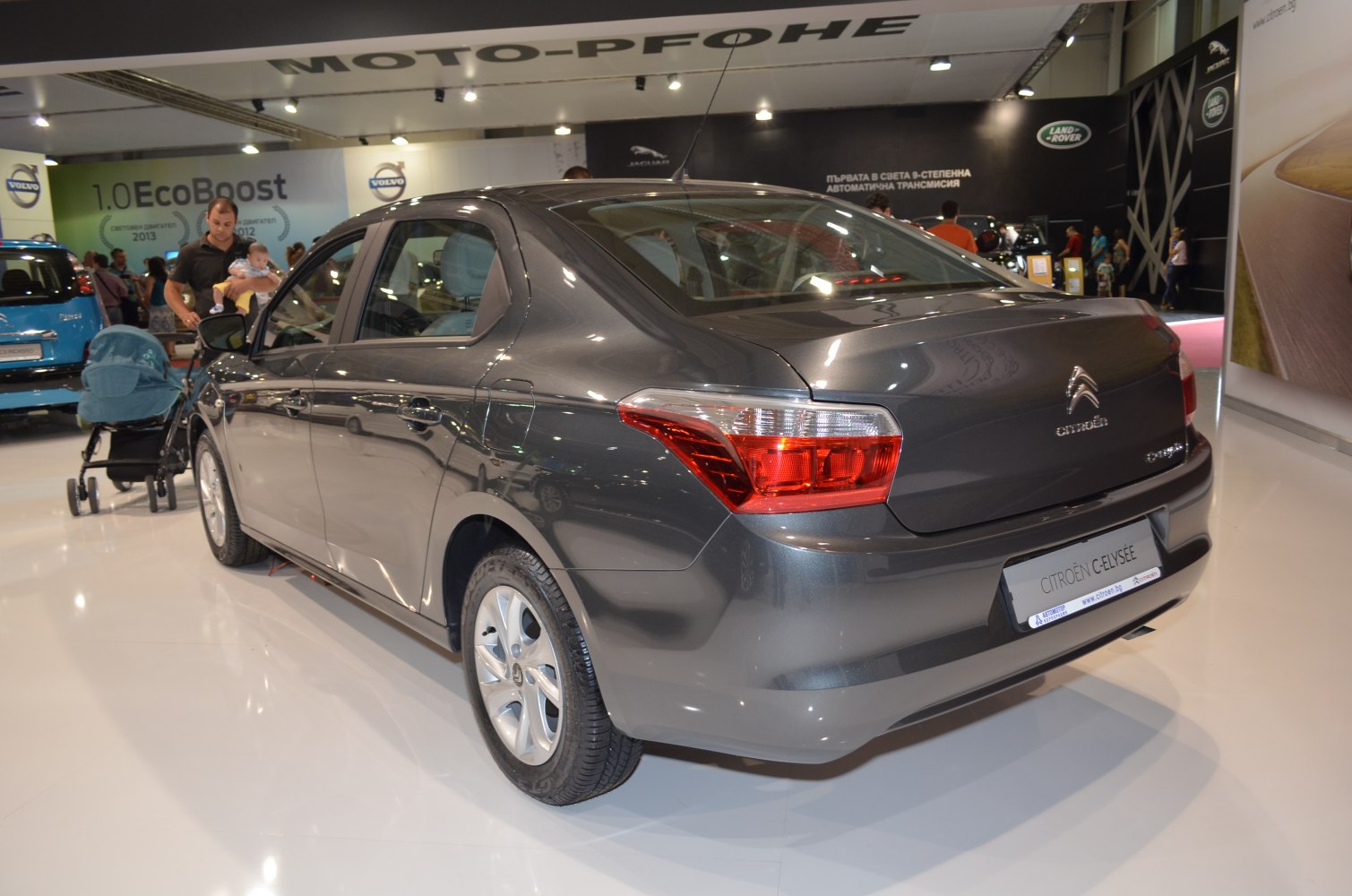Rear and side view of a grey sedan with distinct tail lights and alloy wheels