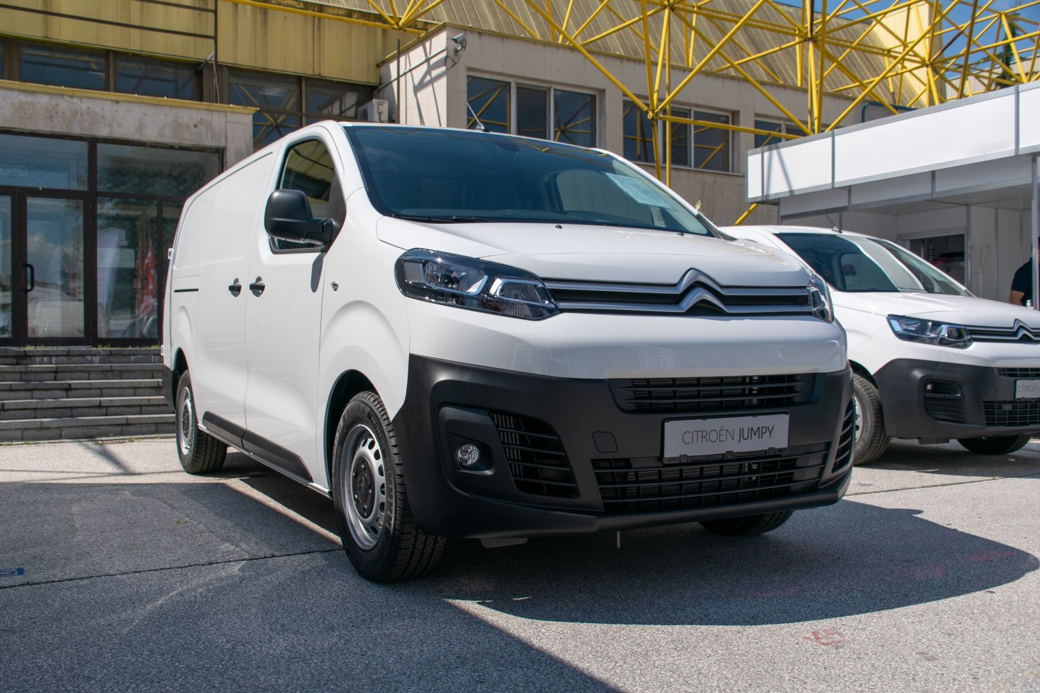 Front view of white panel van with black bumper and steel wheels