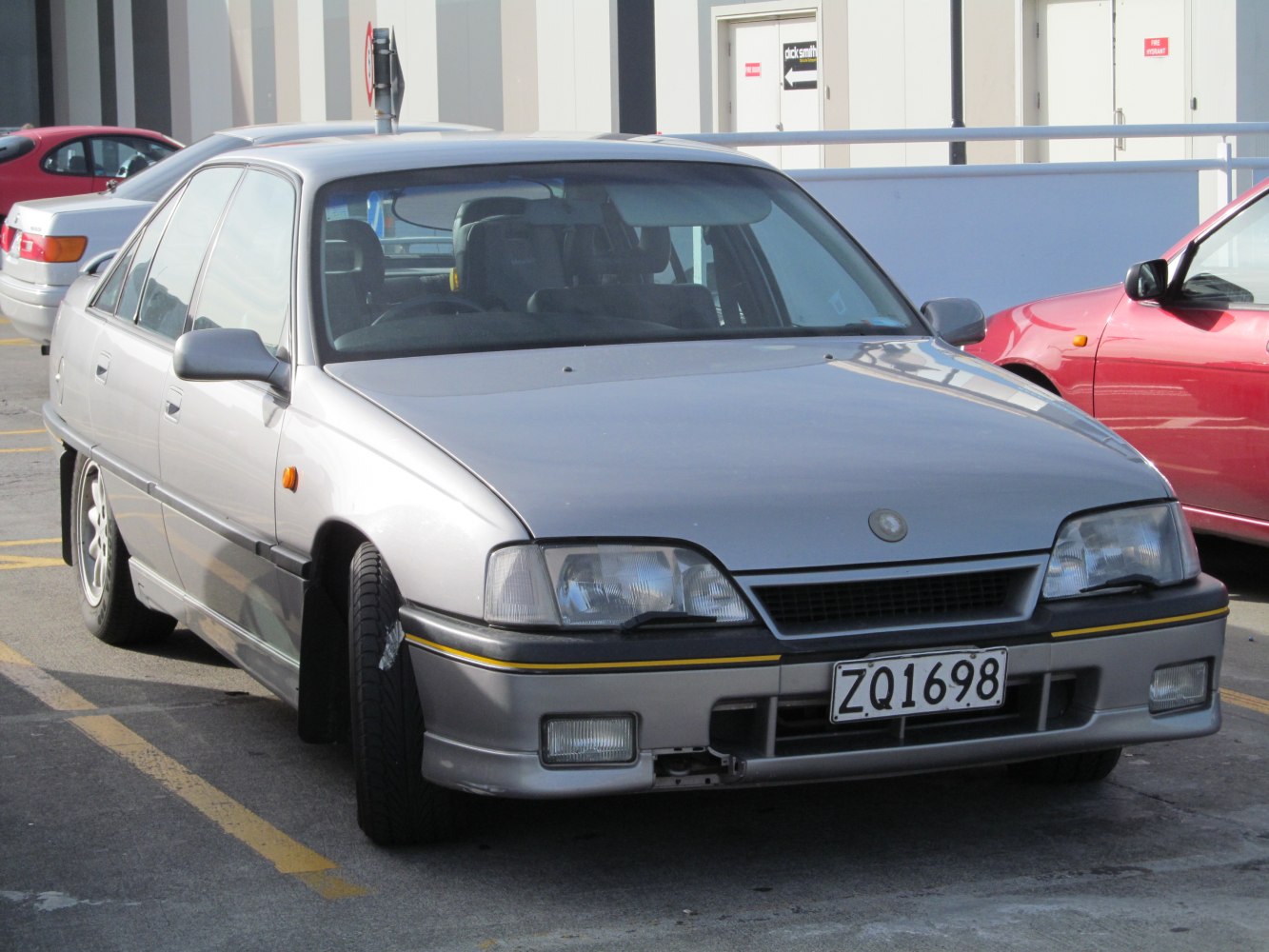 Front angle of sedan with quad headlights and streamlined bonnet