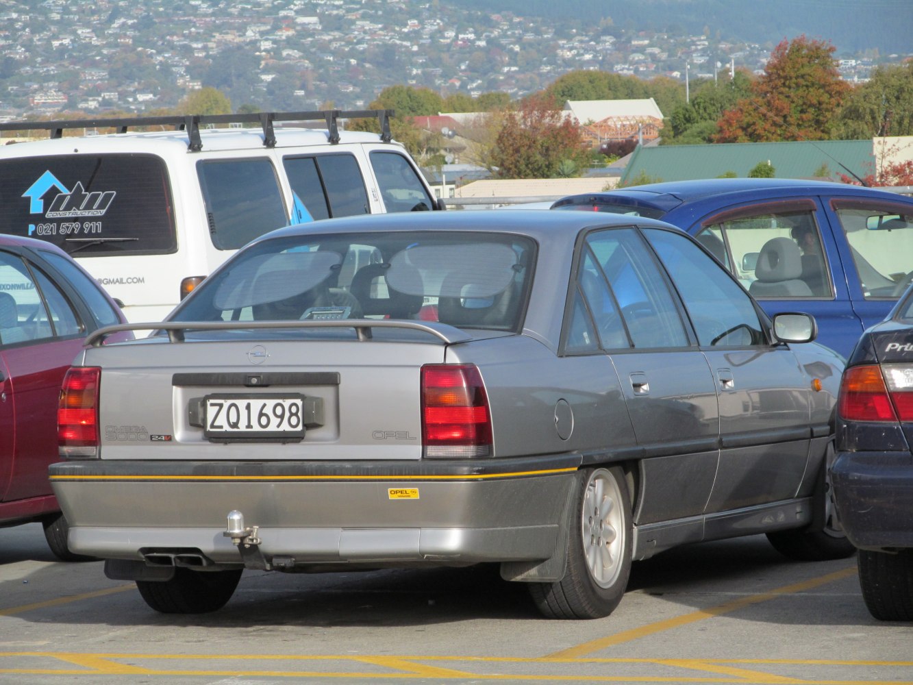 Rear view of sedan with distinct taillights and trunk spoiler