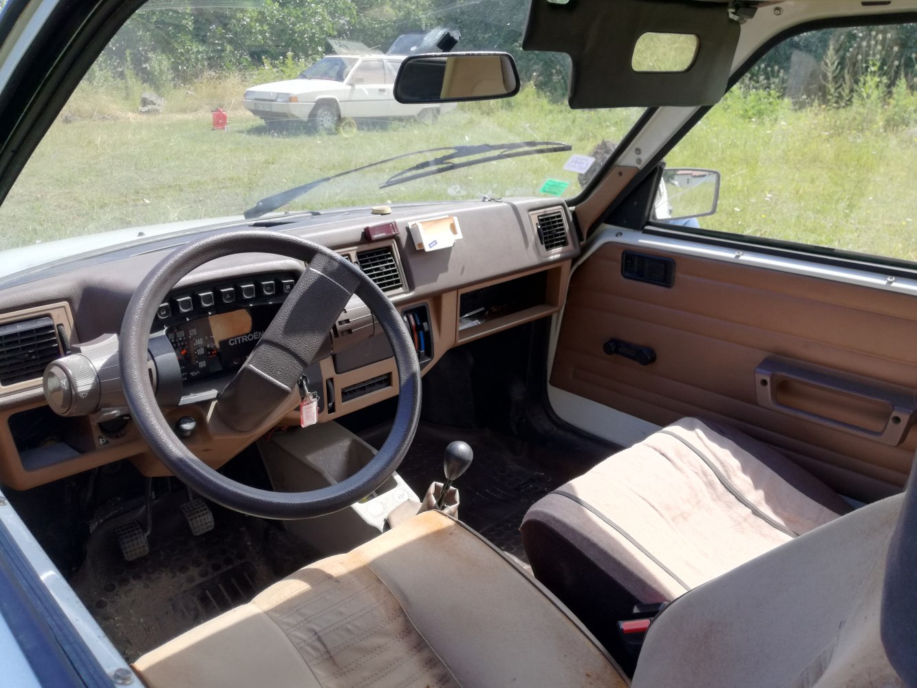 Dashboard, steering wheel, manual gearshift inside car cabin