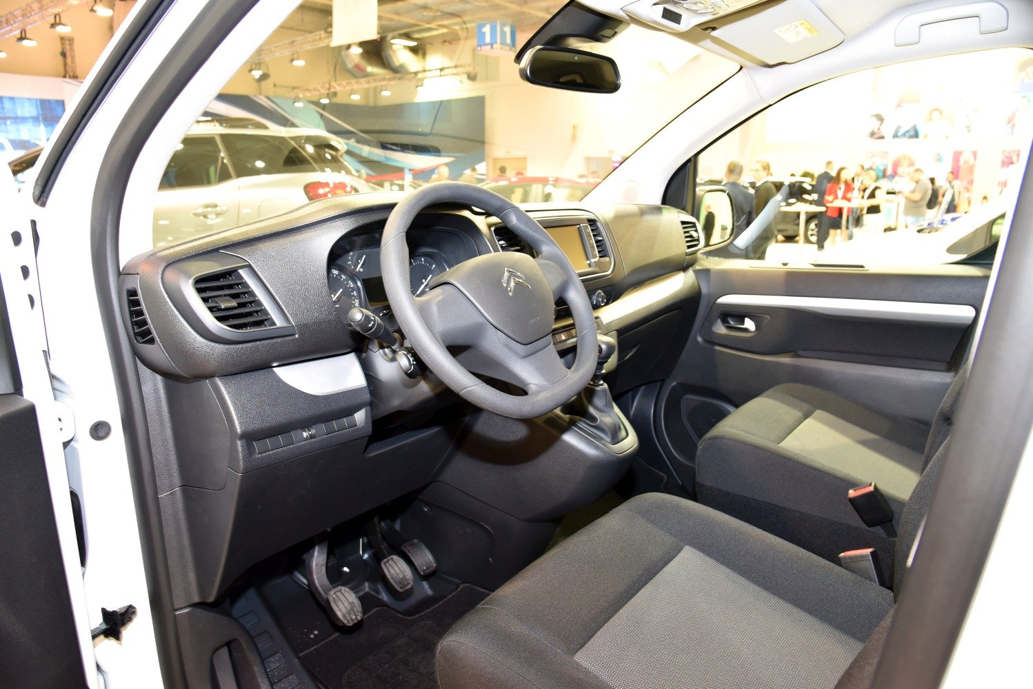 Van interior with steering wheel and dashboard.