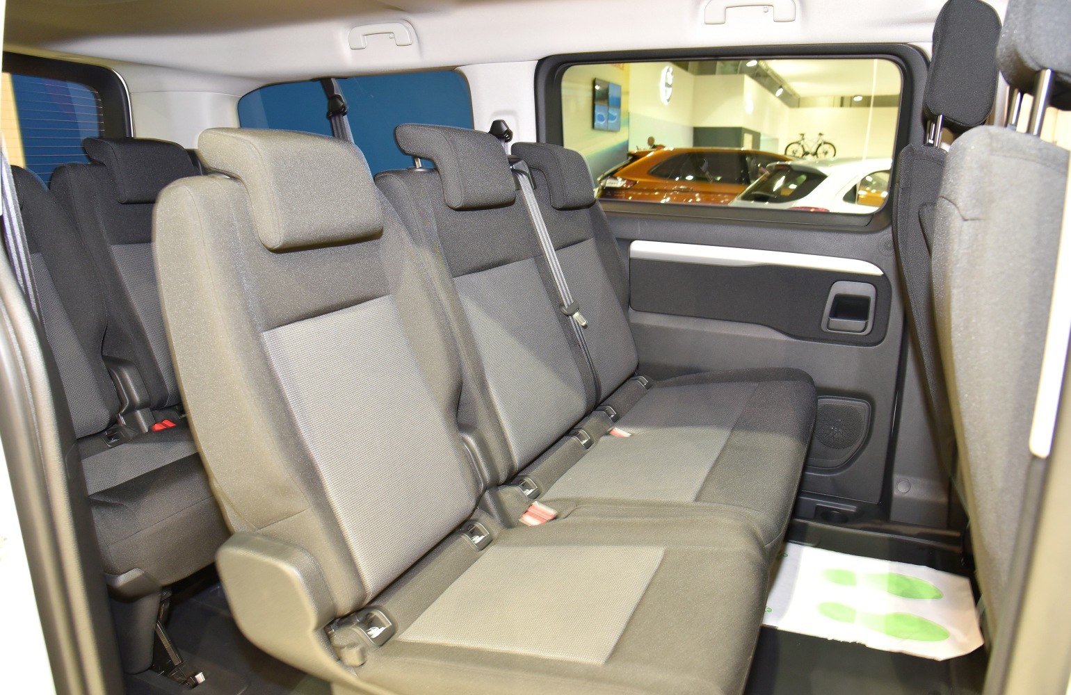 Spacious multi-row rear passenger seats with headrests and seat belts