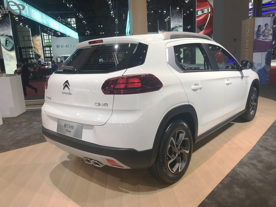 Rear and side view with tail lights and dual exhausts.