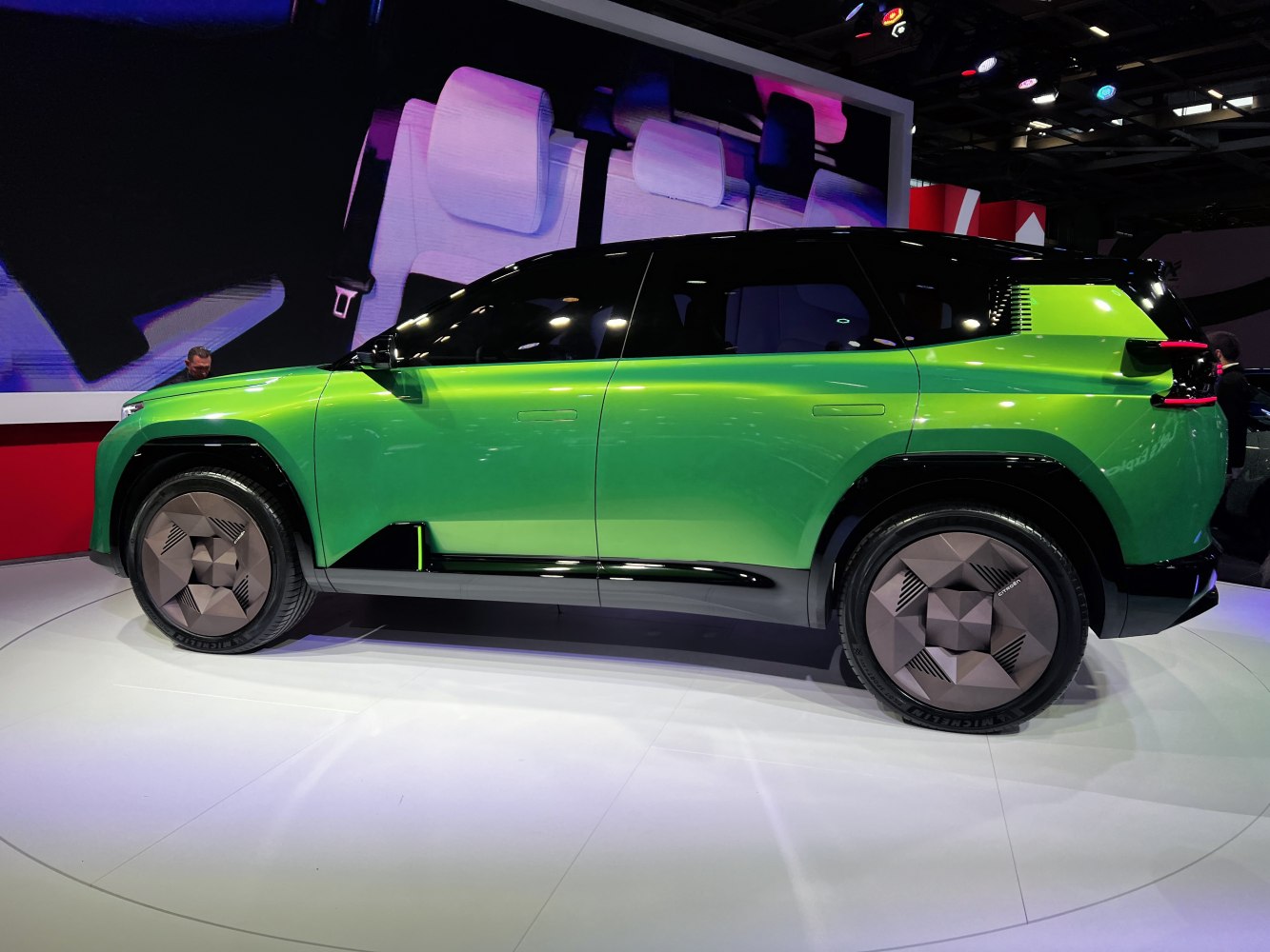 Side view of futuristic green SUV with geometric wheels