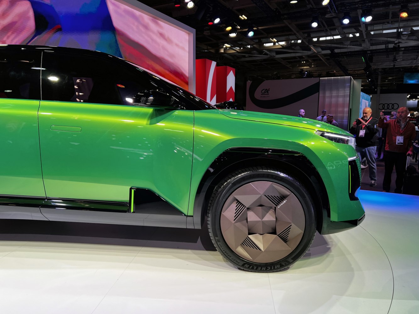Futuristic green SUV with geometric wheel design