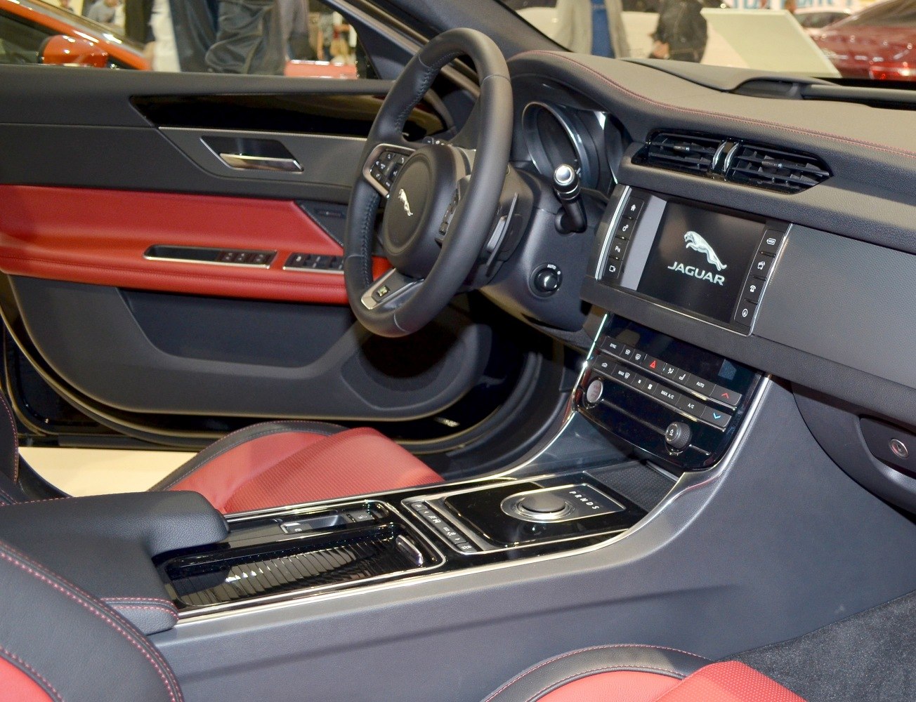 Luxury car interior with red leather seats and advanced dashboard controls