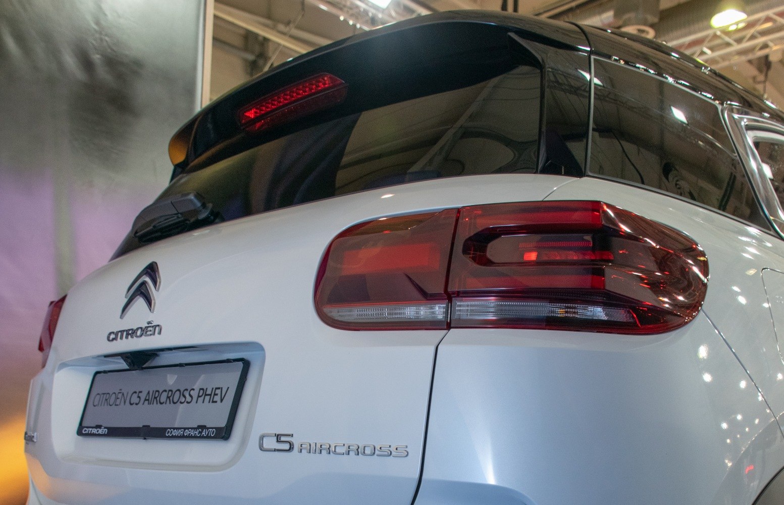 Rear design and taillights of a modern SUV with white body and black roof.