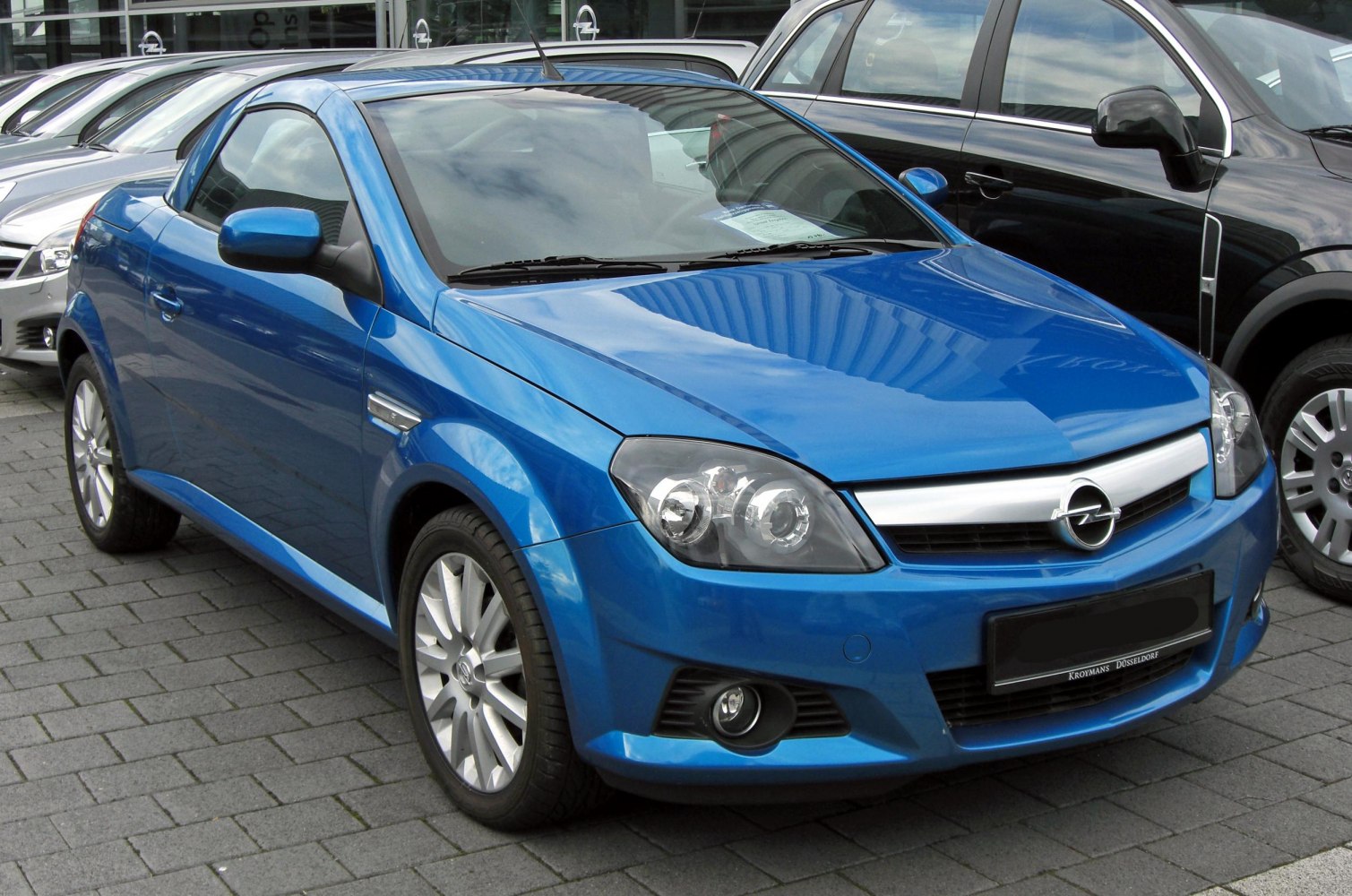 Blue convertible coupe with dual headlights and fog lights